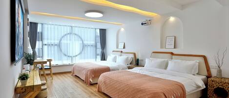 A modern hotel room with two beds, a wooden floor, a large window with curtains, a flat-screen TV, and a wall-mounted artwork.