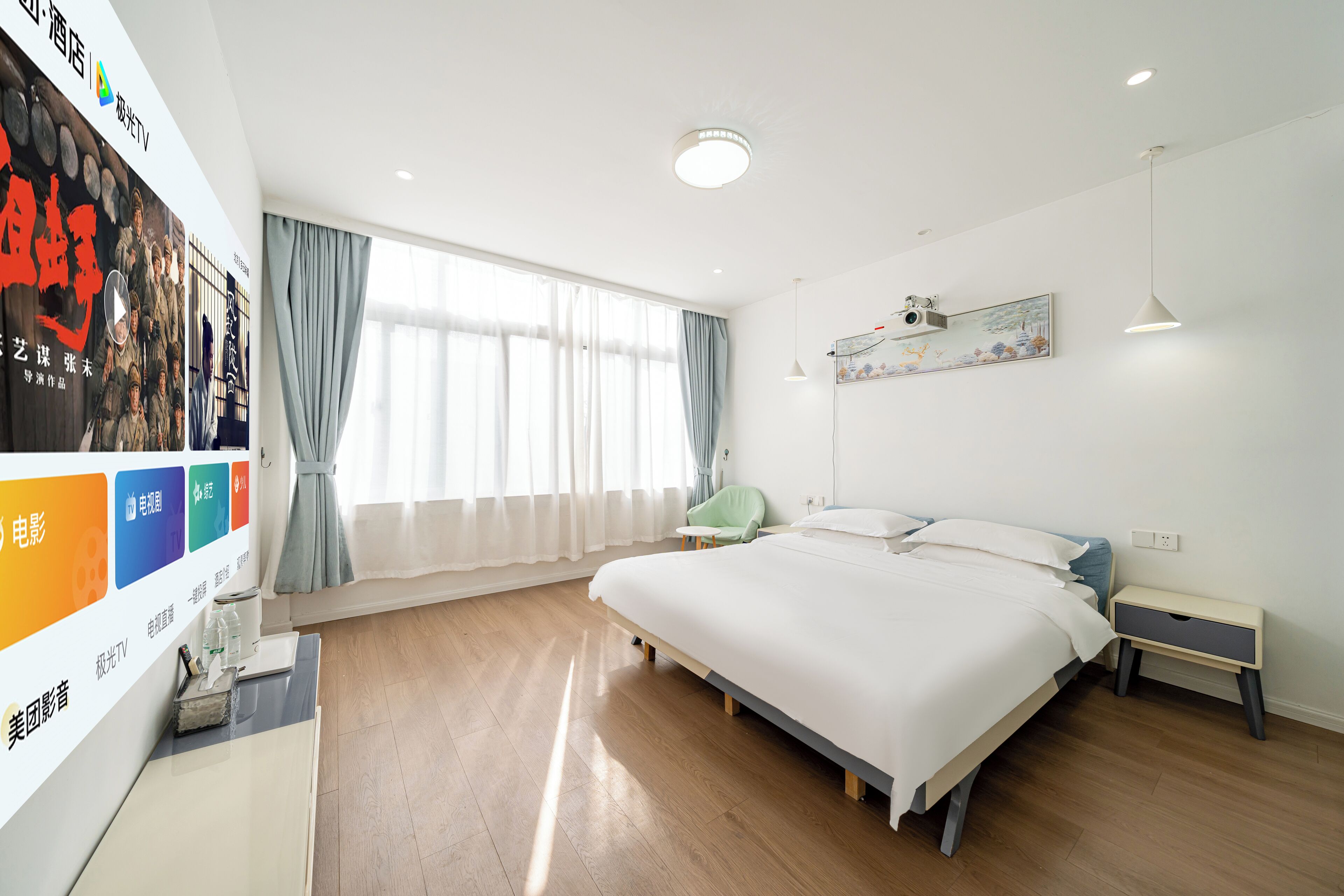 A modern hotel room with a large bed, a bedside table, a nightstand, a window with curtains, and a wall-mounted artwork.
