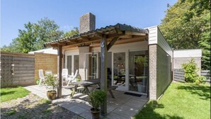 A small house with a patio, a chimney, and a number 4 on the wall.