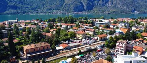 A town with a train station and a lake in the background.