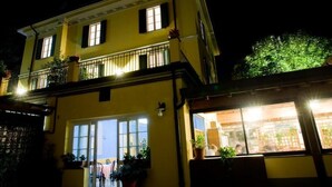 A two-story building with a balcony and large windows. - Albergo Ristorante Grigna (Mandello del Lario)