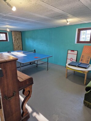 Enjoy a game of ping pong or work from the comfort of this room, featuring a desk and a window with a view.