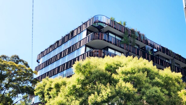A multi-story building with balconies, surrounded by trees. - Penthouse perfection with private rooftop pool paradise. 2 bed, 2 bath, parking (Waterloo)