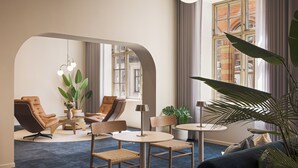 A modern lounge area with leather chairs, a round table, and a large window with curtains. - BREEZE Bergen City - Self-Service (Bergen)