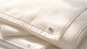 A folded white towel with a tag.