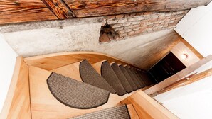 A sauna with wooden benches and a stone wall.