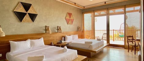 A hotel room with two beds, a ceiling fan, and a balcony with a chair.