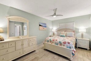 A bedroom with a bed, dresser, nightstands, and a ceiling fan. - The Riverside Club - B204 (Marco Island)