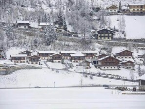 A snow-covered village with traditional chalet-style buildings.