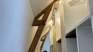 A narrow, wooden-framed staircase with a series of lights along the handrail, leading to upper floors. - Holiday Home Near Dunes, Beach, sea (Sint Maartensvlotbrug)