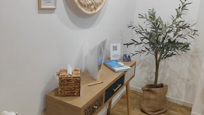 A wooden desk with a plant, a framed picture, and a notebook. - Roman luxury location, St. Peter's  (Roma)