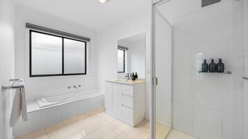 Shower, hair dryer, towels, shampoo