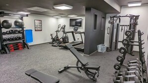 A gym with exercise equipment, a bench, and dumbbells. - Student Only Merchant Studios in Glasgow (Glasgow)