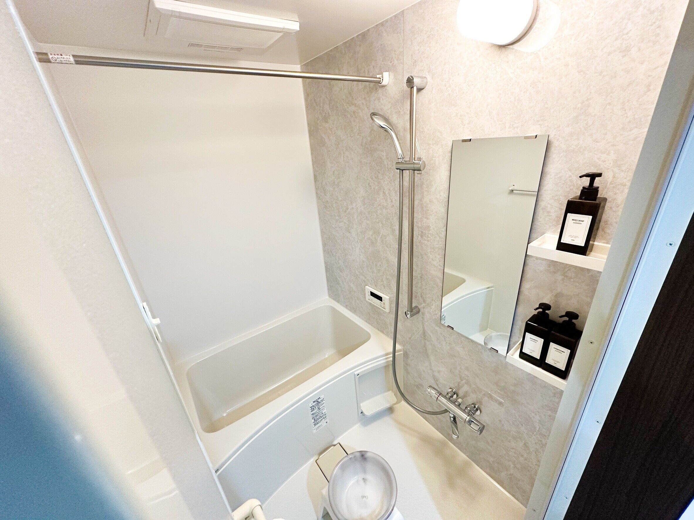 A modern bathroom with a walk-in shower, a bathtub, a toilet, and a sink.