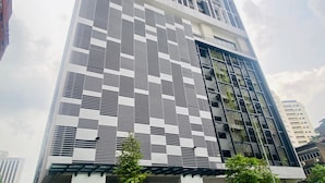 A modern building with a distinctive facade featuring a geometric pattern.