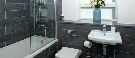 Shower, hair dryer, towels, shampoo