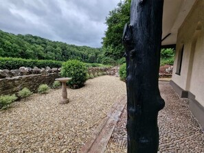 Escape to a serene retreat surrounded by lush greenery and a stone wall.