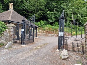 Welcome to Coombe Lodge, a traditional retreat surrounded by lush greenery.