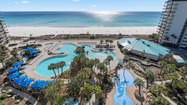 A resort with a large pool area, a beach, and a view of the ocean. - Edgewater Beach Front T3 Sleeps 4 book with us now! (Panama City Beach)