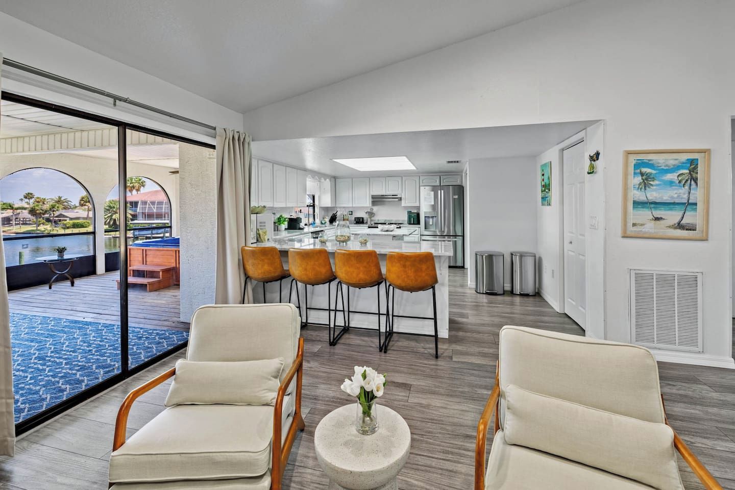 Gather and create memories in this bright and open living area with a modern kitchen.
