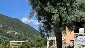 A villa named "Villa Eleanor" with a stone entrance, a large tree, and a view of a mountainous landscape. - Villa Eleanor, Sivota Lefkada - 13 minute walk to the Bay.
Stunning Sea views. (Sivota Bay)