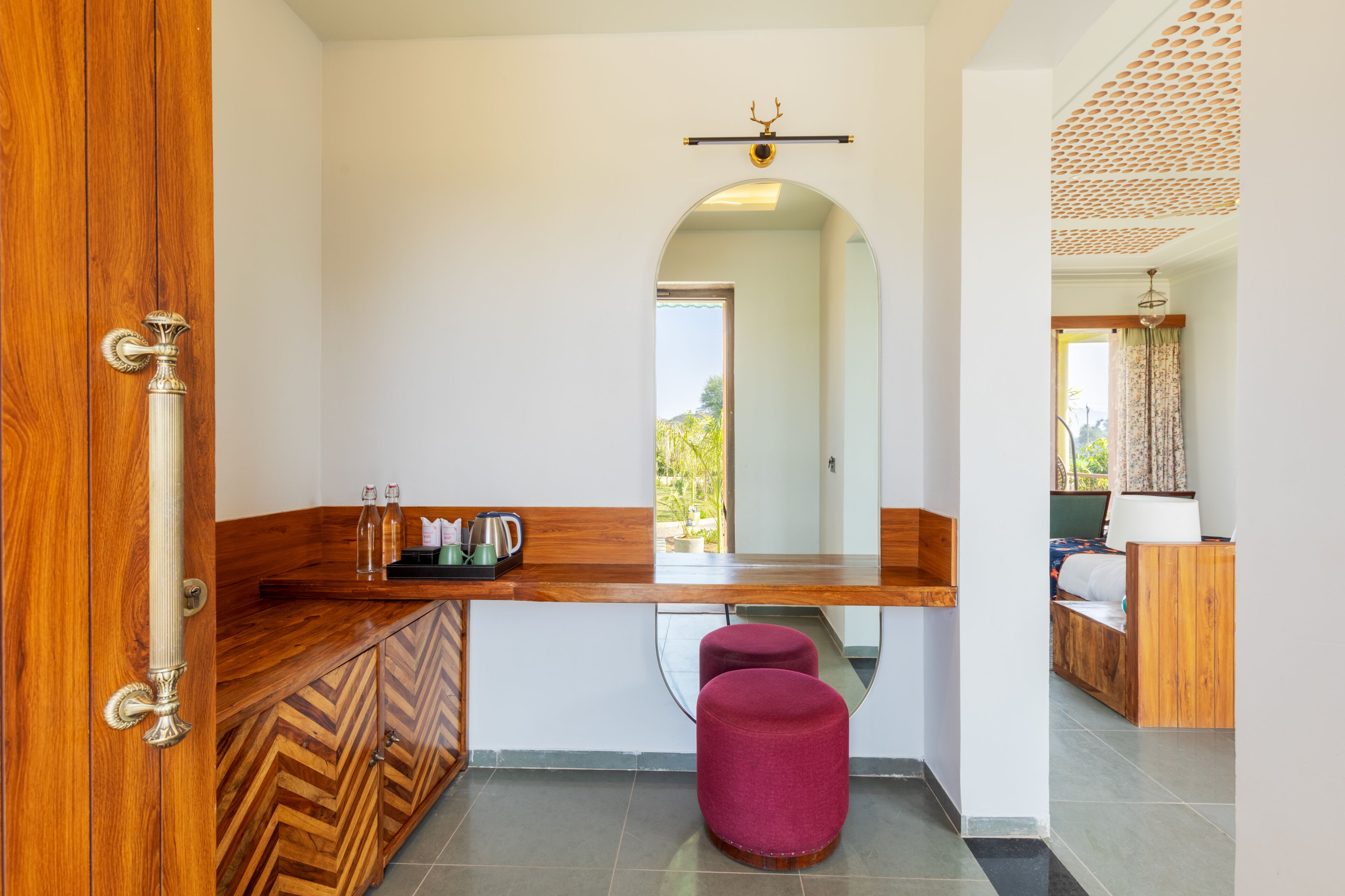 A modern bathroom with a wooden vanity, a mirror, and a sink.