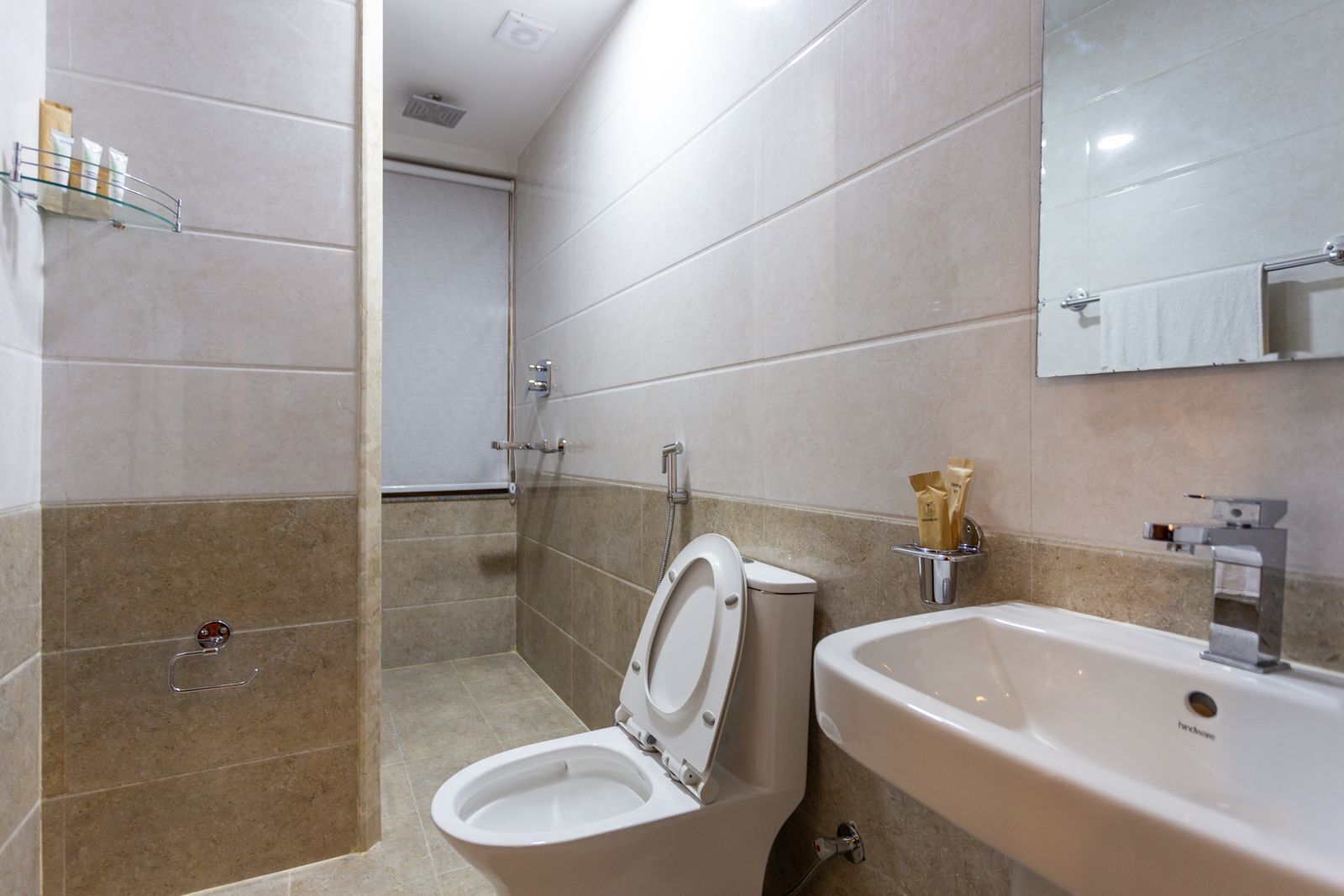 A modern bathroom with a toilet, bidet, and sink.