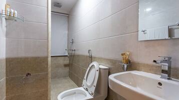 A modern bathroom with a toilet, bidet, and sink.