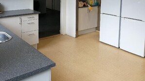 A kitchen with white cabinets, a granite countertop, and a microwave. - 11rum&kök  (Sandviken)