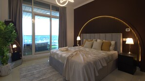 A modern hotel room with a large bed, a view of the city, and a balcony.