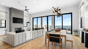 A modern kitchen with a dining area, large windows, and a view of the ocean. - Casita Bonita at Eleanor Beach (Pensacola)