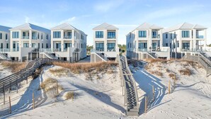 A beachfront property with multiple white buildings featuring balconies and large windows. - Casita Bonita at Eleanor Beach (Pensacola)