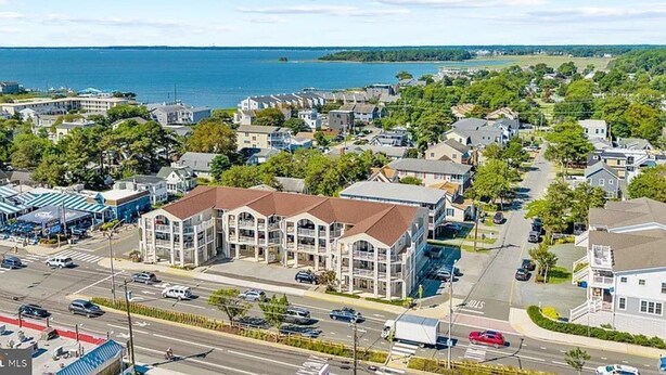 A coastal town with a prominent building featuring a large bay window and a central entrance. - Spacious 4-bedroom condo steps from The Starboard in Dewey Beach (Dewey Beach)
