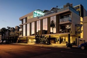 A hotel with a prominent sign, a covered entrance, and a visible entrance. - The Bower Coronado (Coronado)