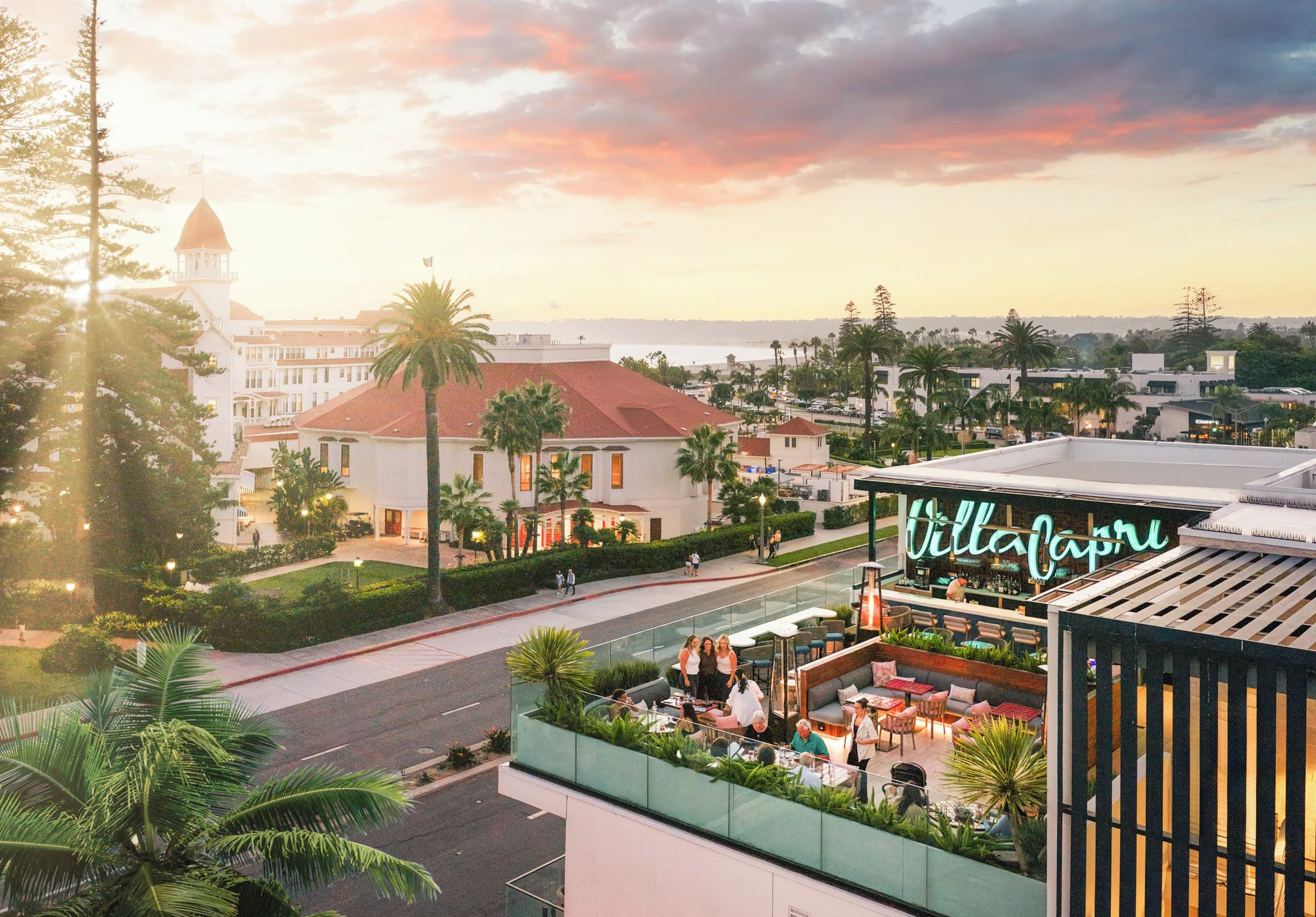 A rooftop bar with outdoor seating and a view of the cityscape.