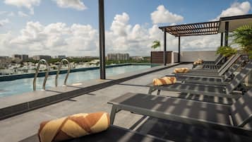 Outdoor pool, open 8:00 AM to 8:00 PM, pool umbrellas