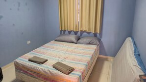 A bedroom with a bed, pillows, and a window with curtains. - Beach house in Itamaraca (Jaguaribe Ilha de Itamaracá)