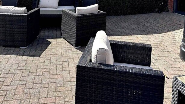 An outdoor seating area with wicker furniture and a wall with the text "the terrace". - Harwich - Caravan - Sleeps 10 - Garden - Pool (Harwich)