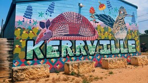 A colorful mural with a bird and the word "KERRYVILLE" on a building.