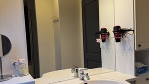 A modern bathroom with a white sink, double vanity, and a large mirror with integrated lighting. - Lovely 3-star country house, ideal for a family. (LEUTENHEIM)