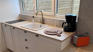 Une cuisine moderne équipée d’un évier, d’un plan de travail et de placards.