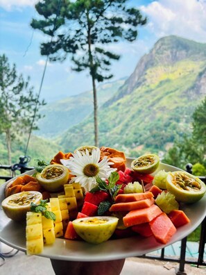 A fruit platter with a mountain view in the background. - Belmount Ella (Ella)