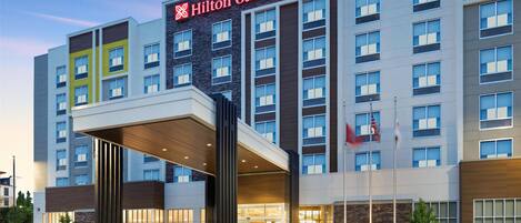 A Hilton Garden Inn hotel with a modern facade, large windows, and a prominent entrance.
