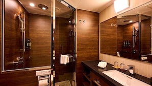 A modern bathroom with a glass-enclosed shower, a large mirror, and a dark wood finish. - Sora Niwa Terrace Kyoto (Kyoto)