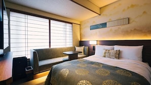 A hotel room with a bed, a sofa, a small table, and a large window with blinds. - Sora Niwa Terrace Kyoto (Kyoto)
