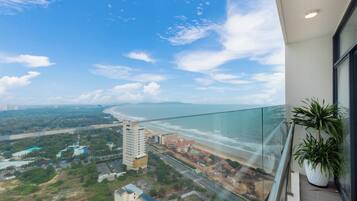 Deluxe Apartment, Partial Sea View | Living area | 32-inch Smart TV with cable channels