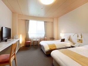 A hotel room with a bed, a desk with a television, a chair, a small table, and a window with curtains. - Chateraise Hotel Isawa (Fuefuki)