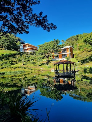 A modern house with a large garden and a pond. - Burbi Lake Lodge (Cabeceras)