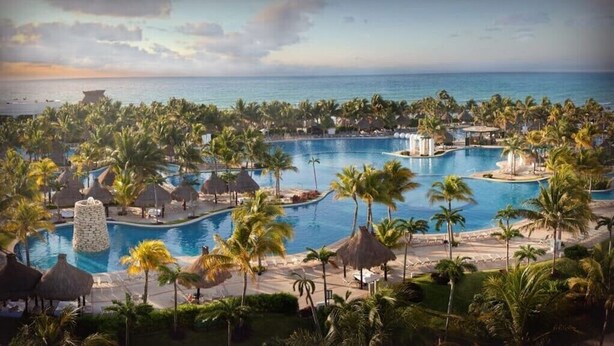 A resort with multiple swimming pools, palm trees, and a beach view. - 2BD Grand Bliss Vidanta Resort RM (Playa del Carmen)