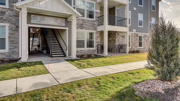 A multi-story residential building with a covered entryway, a visible staircase, and a landscaped front yard. - 15 Mi to Sundance: Pet-Friendly Condo in Vineyard (Vineyard)